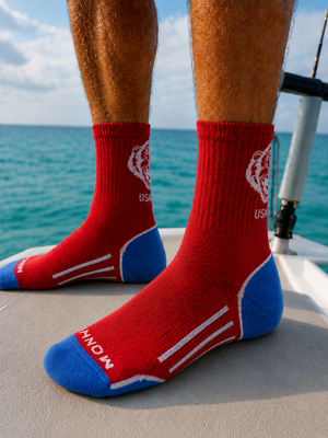 Fish Monkey Americana SM225 merino socks worn on a flats boat
